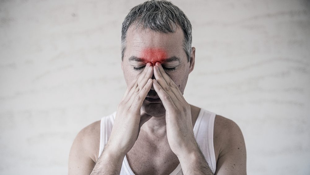 man-holds-his-nose-sinus-area-with-fingers-obvious-pain-from-head-ache-front-forehead-area-sinus-pain-1000x565-1